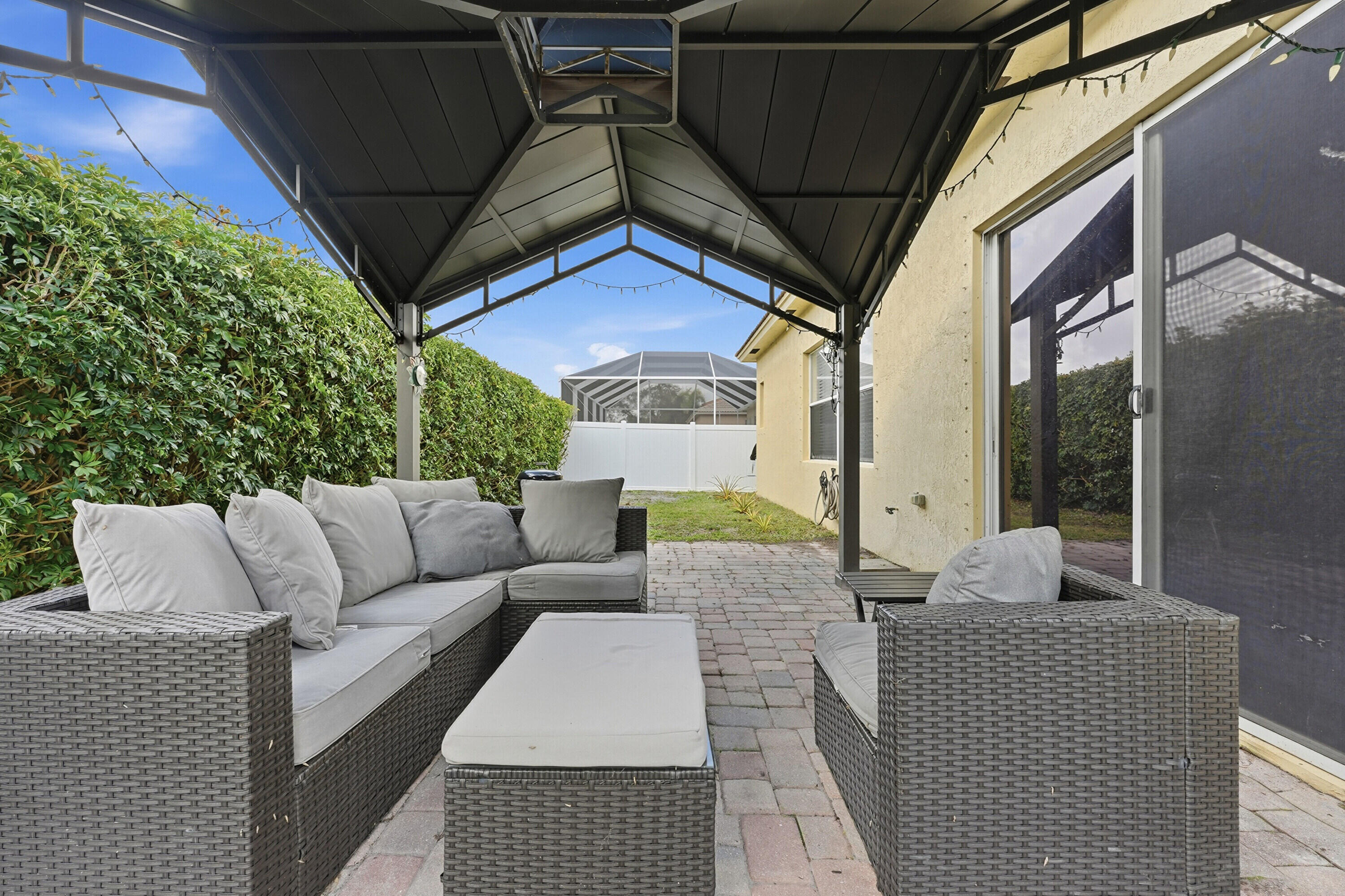 6117 Spring Lake Terrace Fort Pierce, FL 34951 - Photo 32 of 38 a balcony with furniture and a potted plant