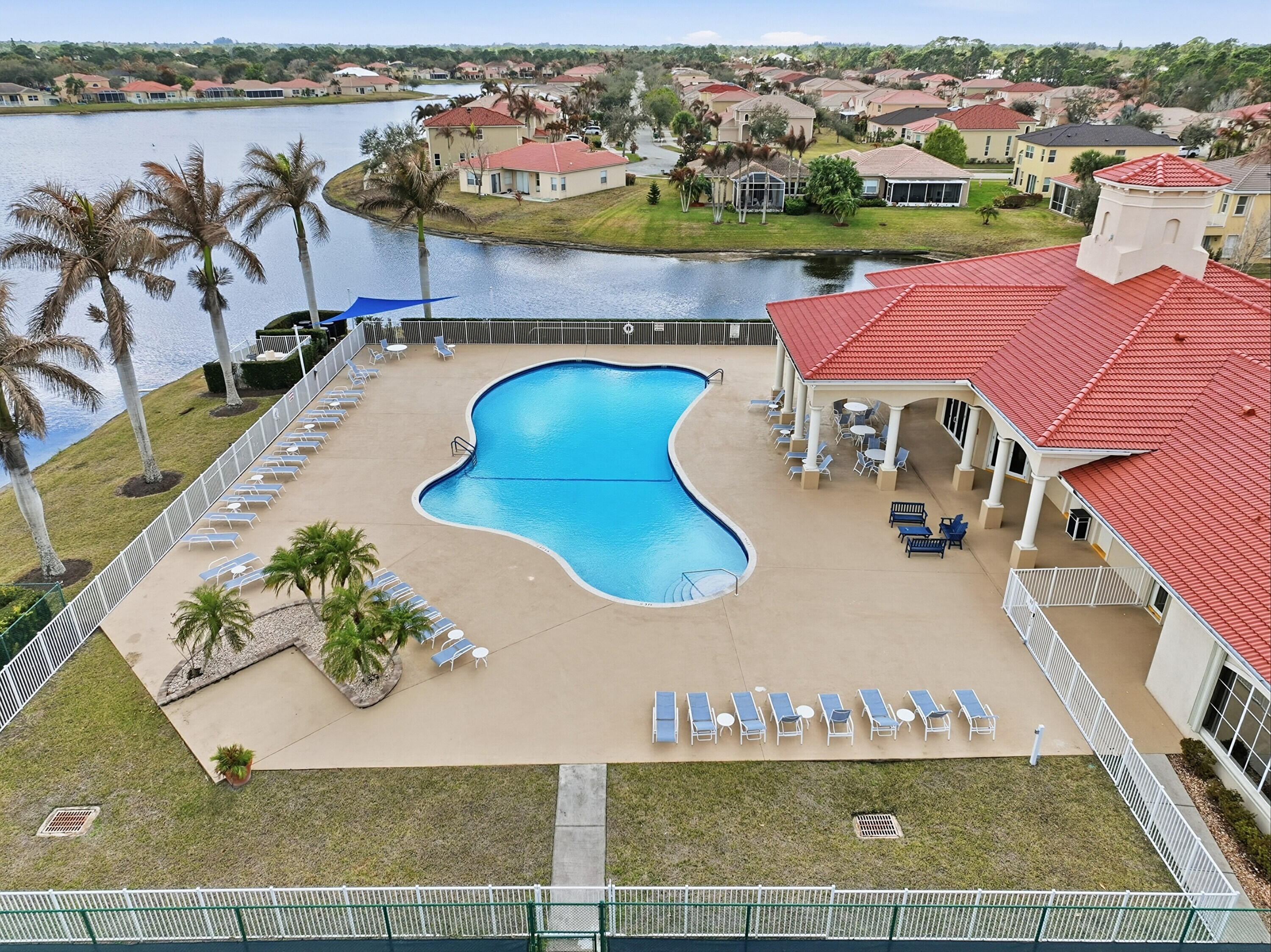 6117 Spring Lake Terrace Fort Pierce, FL 34951 - Photo 36 of 38 an aerial view of a house with a swimming pool yard and lake view