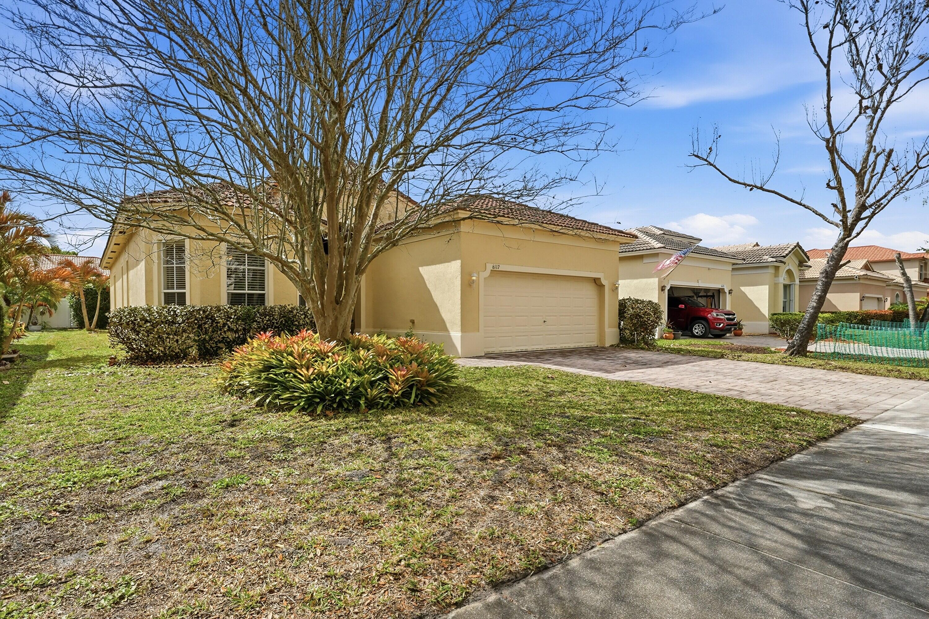 6117 Spring Lake Terrace Fort Pierce, FL 34951 - Photo 4 of 38 a front view of a house with garden