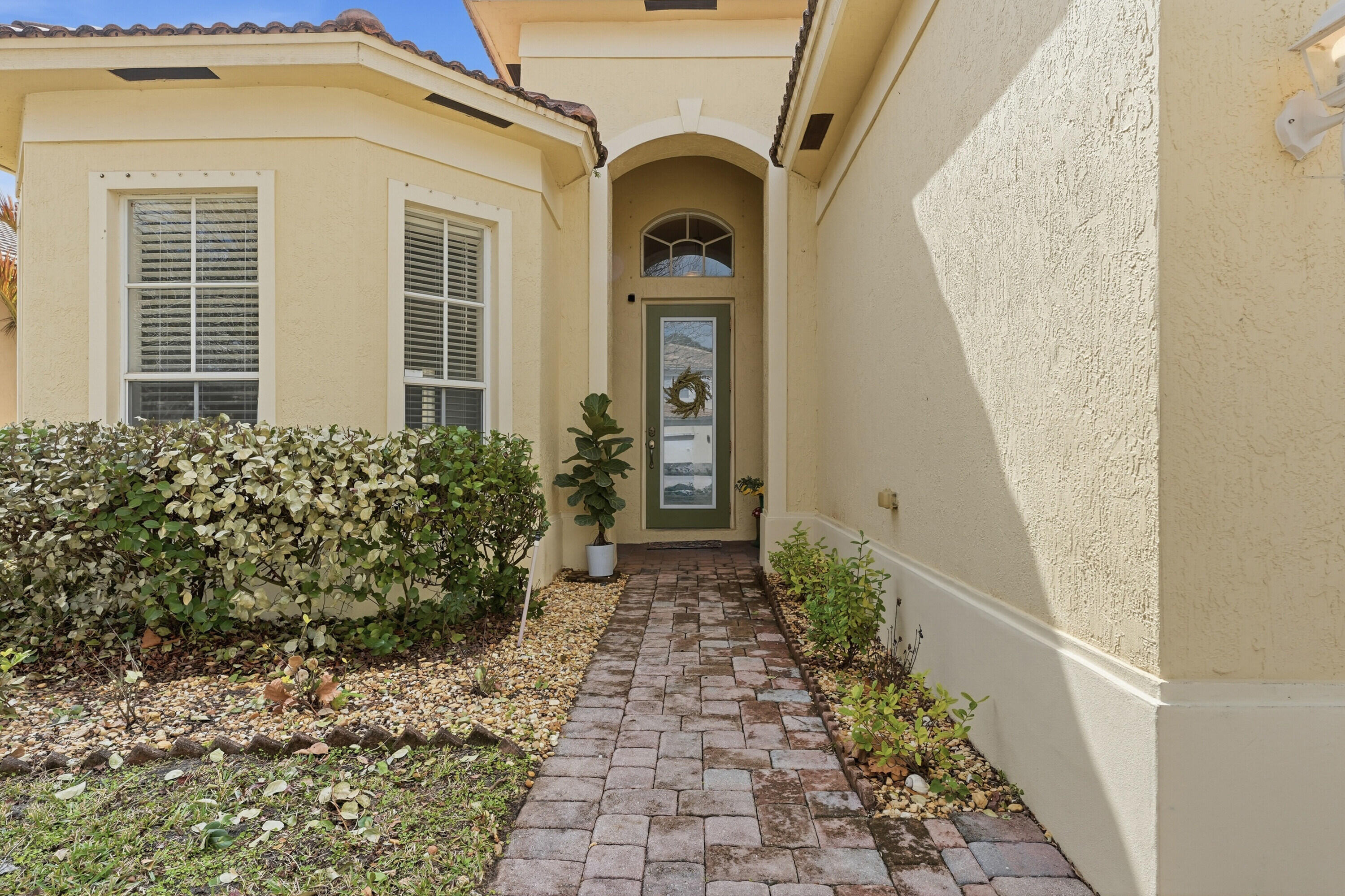 6117 Spring Lake Terrace Fort Pierce, FL 34951 - Photo 5 of 38 a view of a pathway of a house with potted plants