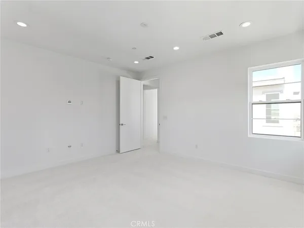 an empty room with a empty space and windows