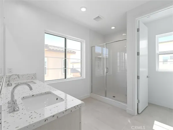 a bathroom with a granite countertop sink a shower and a mirror