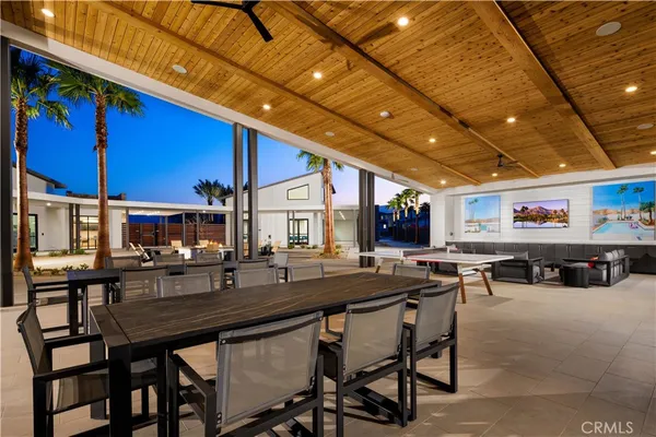 a outdoor dining area with chairs and tables