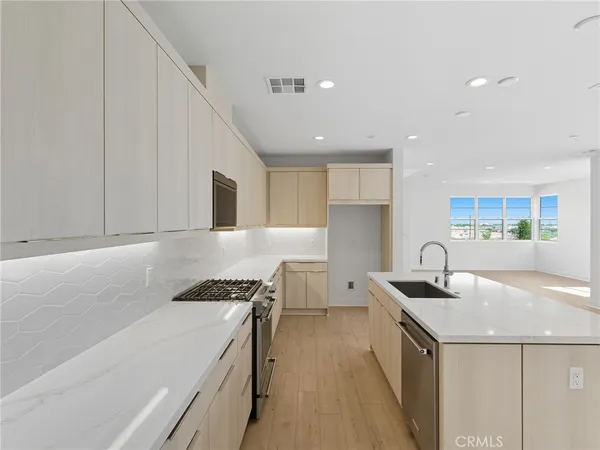 a kitchen that has a sink and a stove in it
