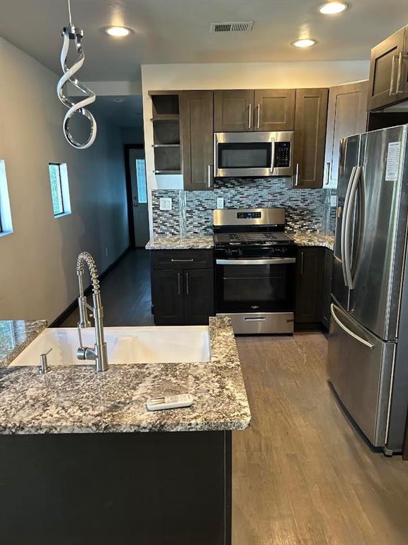 759 Jones Avenue Northwest Atlanta, GA 30314 - Photo 11 of 19 a kitchen with kitchen island granite countertop a stove refrigerator and microwave