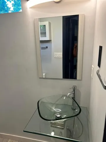 a room with wooden floor and cabinets