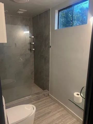 a bathroom with a toilet and a shower