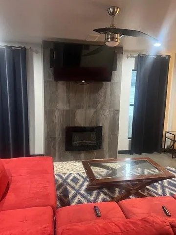 a living room with furniture and a fireplace