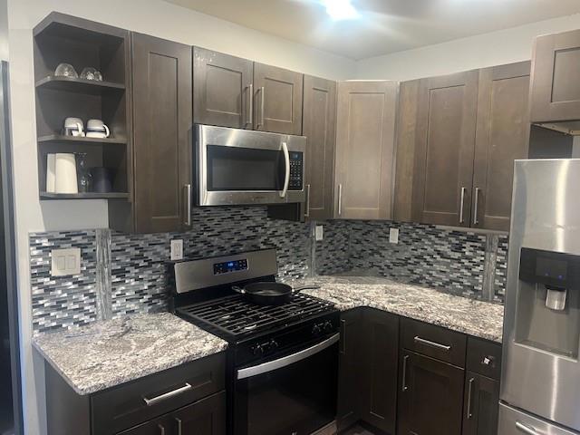 759 Jones Avenue Northwest Atlanta, GA 30314 - Photo 9 of 19 a kitchen with granite countertop a sink stove and refrigerator