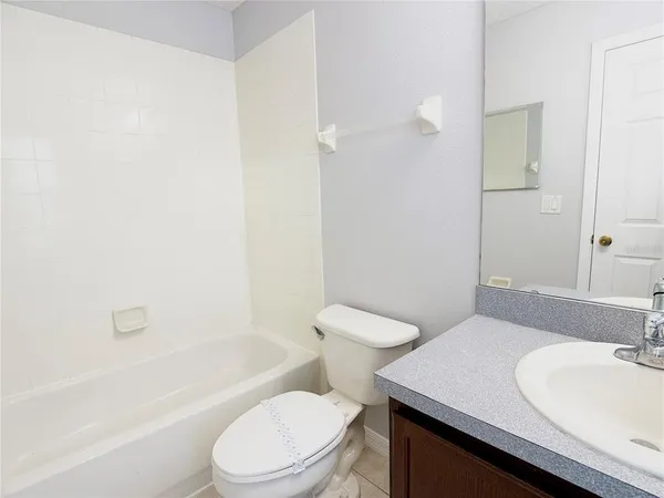 a bathroom with a sink toilet vanity and shower
