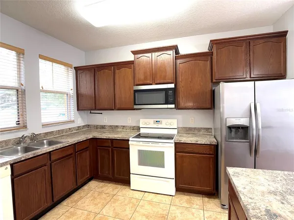 a kitchen with a sink stove and refrigerator