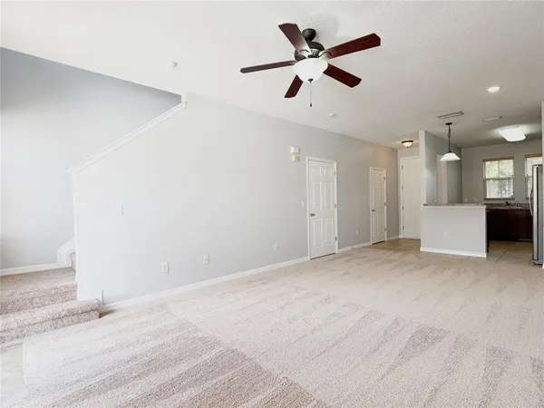 a view of a kitchen with a sink and a ceiling fan
