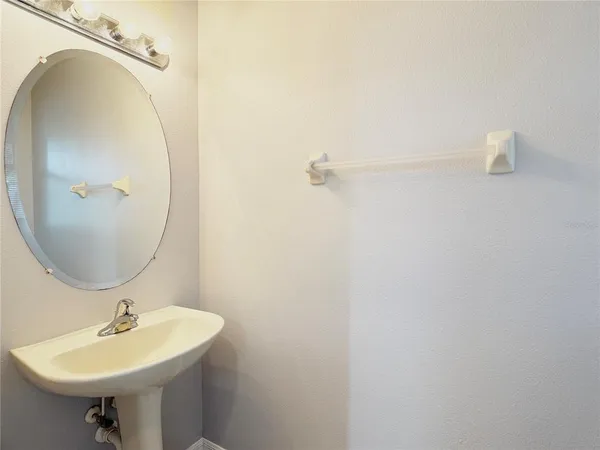 a bathroom with a sink a mirror and vanity