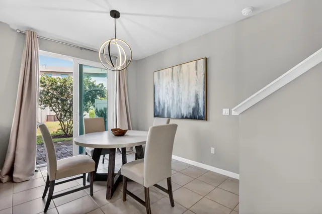 a dining room with furniture window wooden floor and a front door