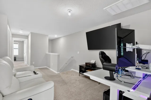 a view of a livingroom with workspace and a couch