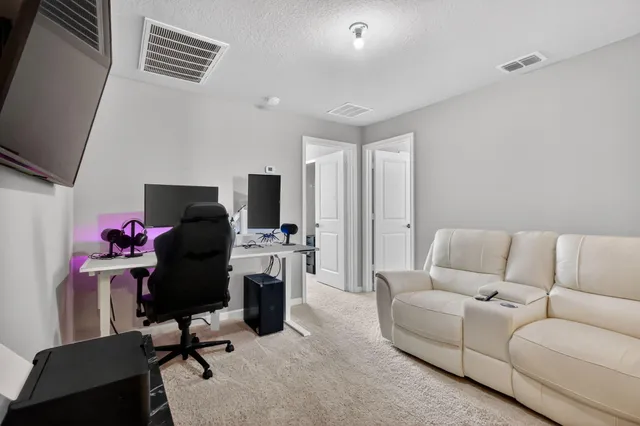 a livingroom with workspace and a couch