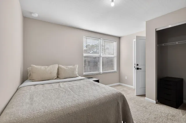 a bedroom with a bed and a window