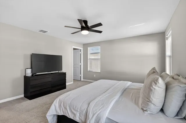 a bedroom with a bed and a flat screen tv