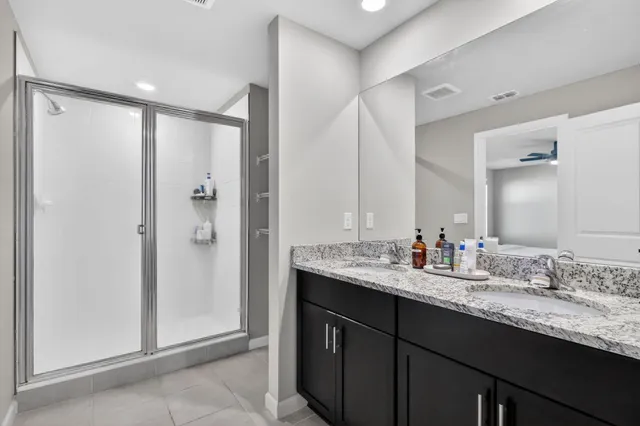 a bathroom with double sink and a mirror