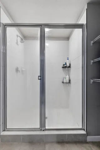a bathroom with a glass shower door