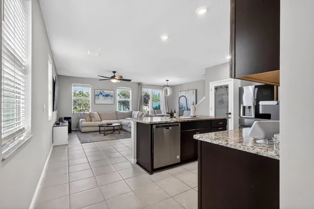 a kitchen with granite countertop a sink and a stove