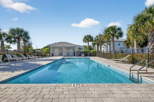 a swimming pool with outdoor seating yard and barbeque oven