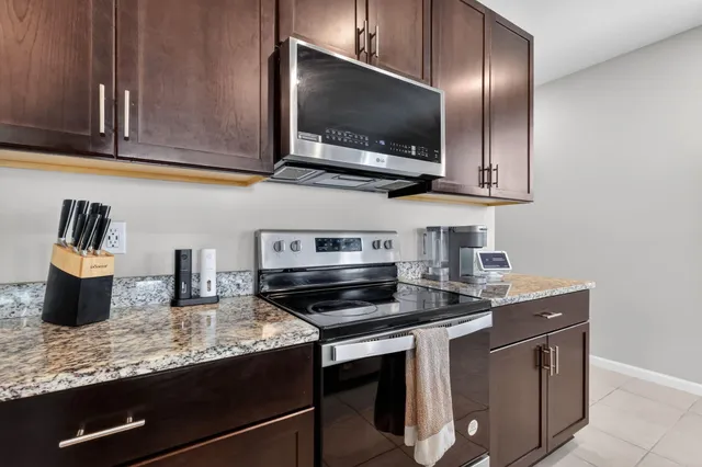 a kitchen with stainless steel appliances granite countertop a sink and a stove