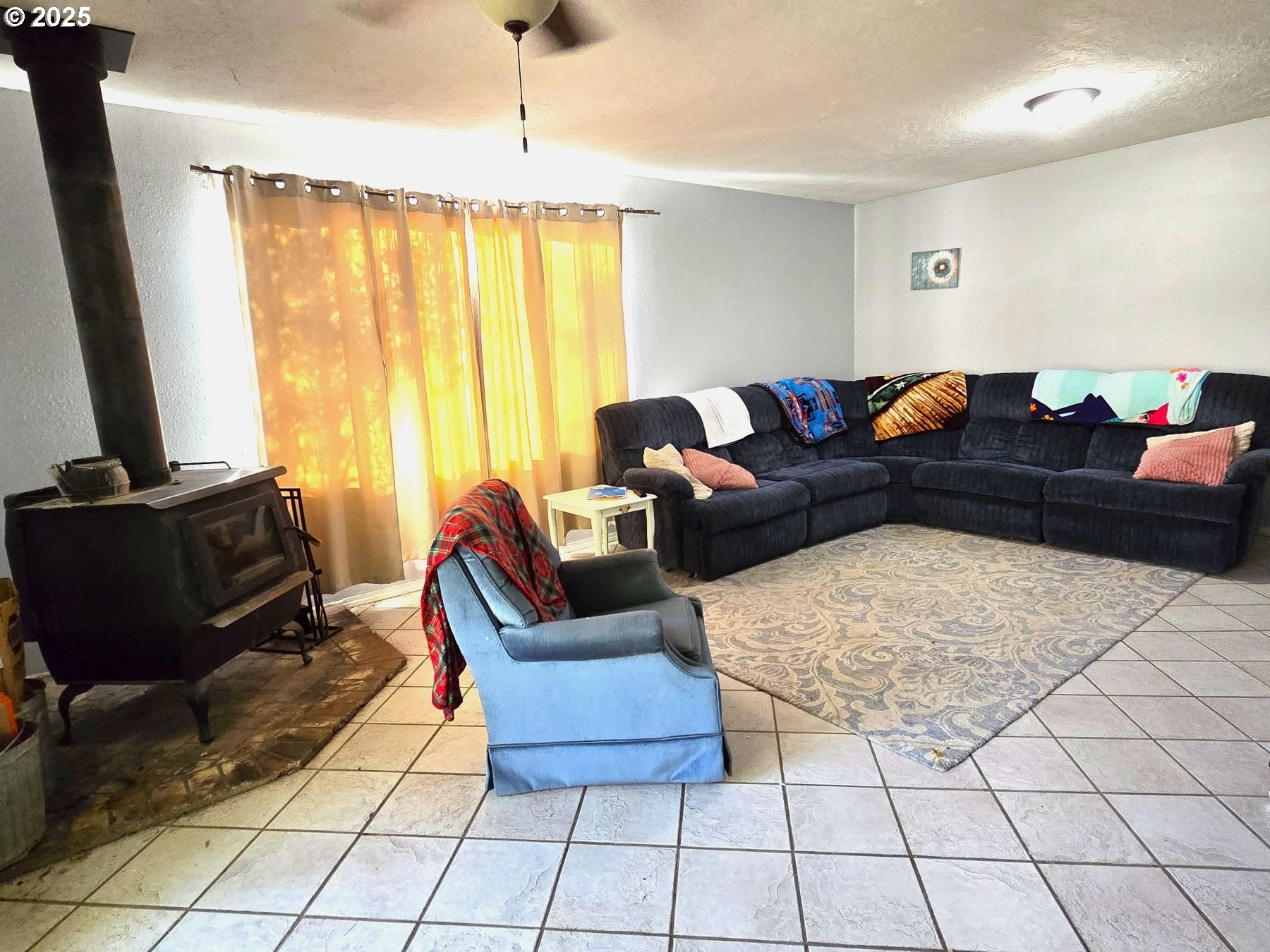 100 Southeast Hillcrest Road John Day, OR 97845 - Photo 12 of 30 a living room with furniture and a flat screen tv