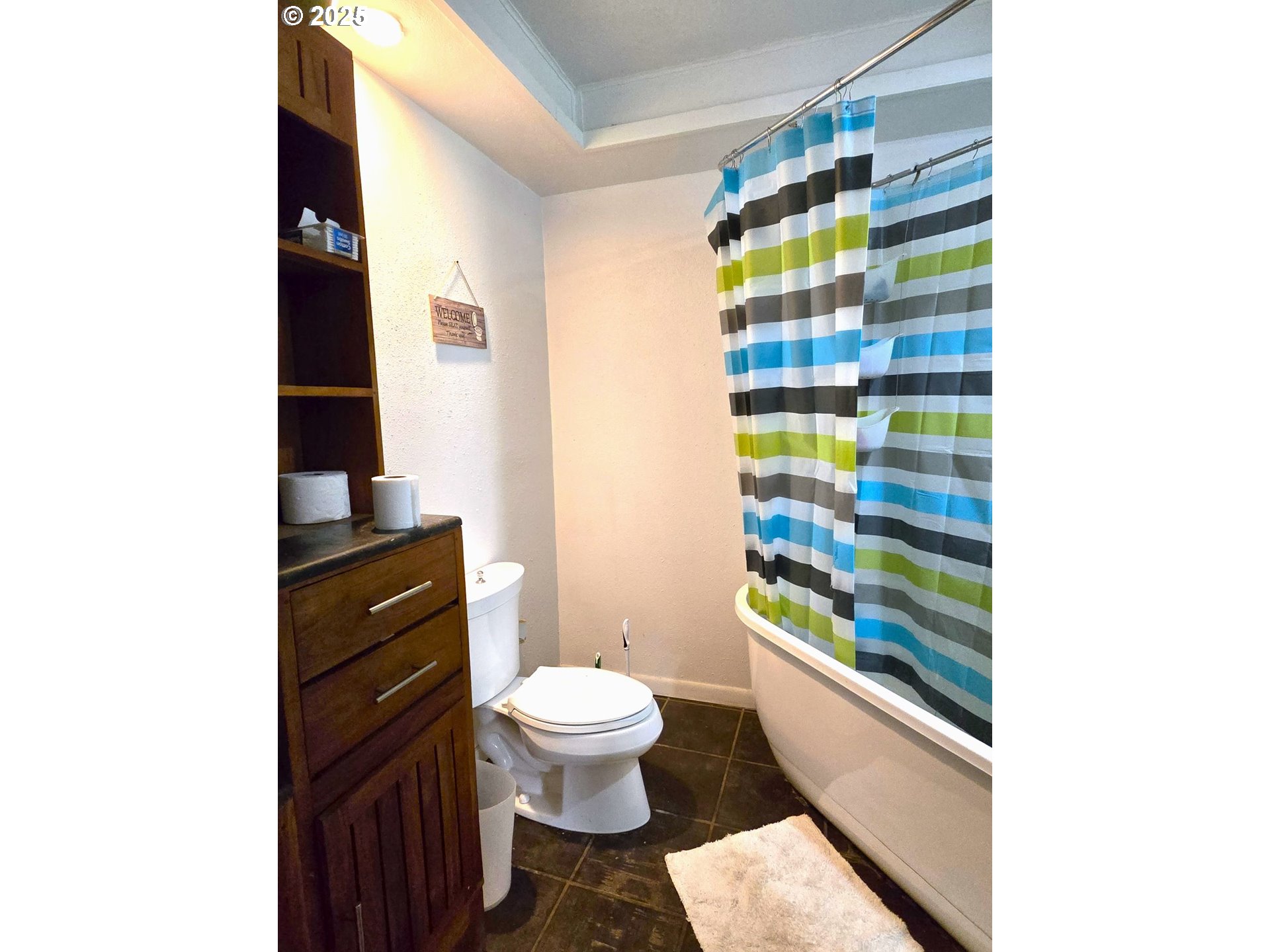 100 Southeast Hillcrest Road John Day, OR 97845 - Photo 15 of 30 a bathroom with a toilet and a shower curtain