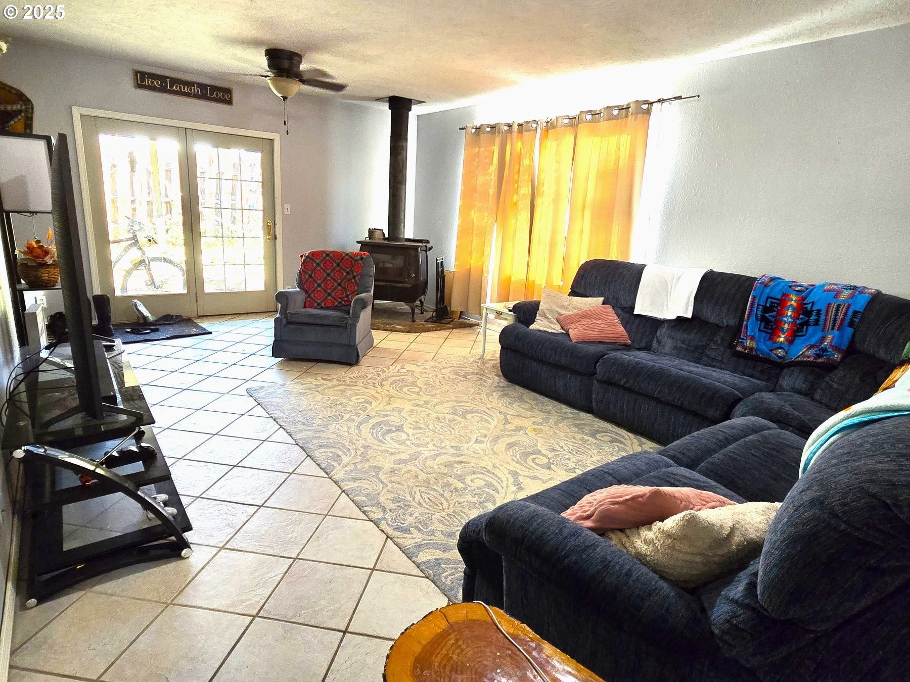 100 Southeast Hillcrest Road John Day, OR 97845 - Photo 10 of 30 a living room with furniture and a flat screen tv