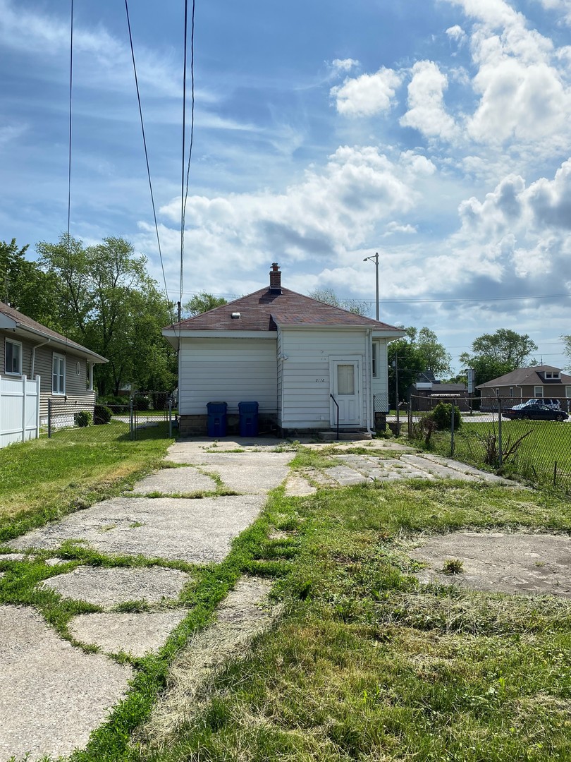 3112 Chicago Road Steger, IL 60475 - Photo 3 of 15 a front view of a house with a yard
