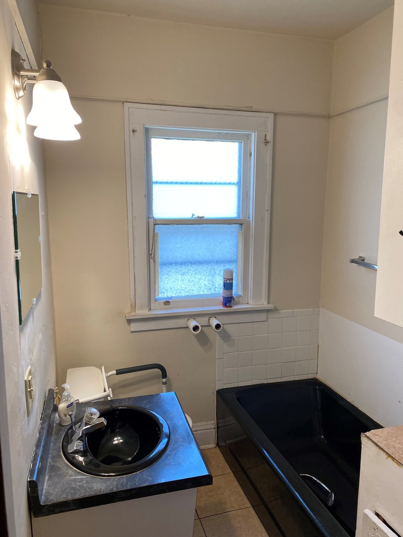 3112 Chicago Road Steger, IL 60475 - Photo 10 of 15 a bathroom with a sink and a window