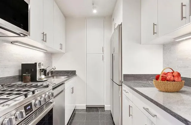 a kitchen with stainless steel appliances granite countertop a sink and a stove