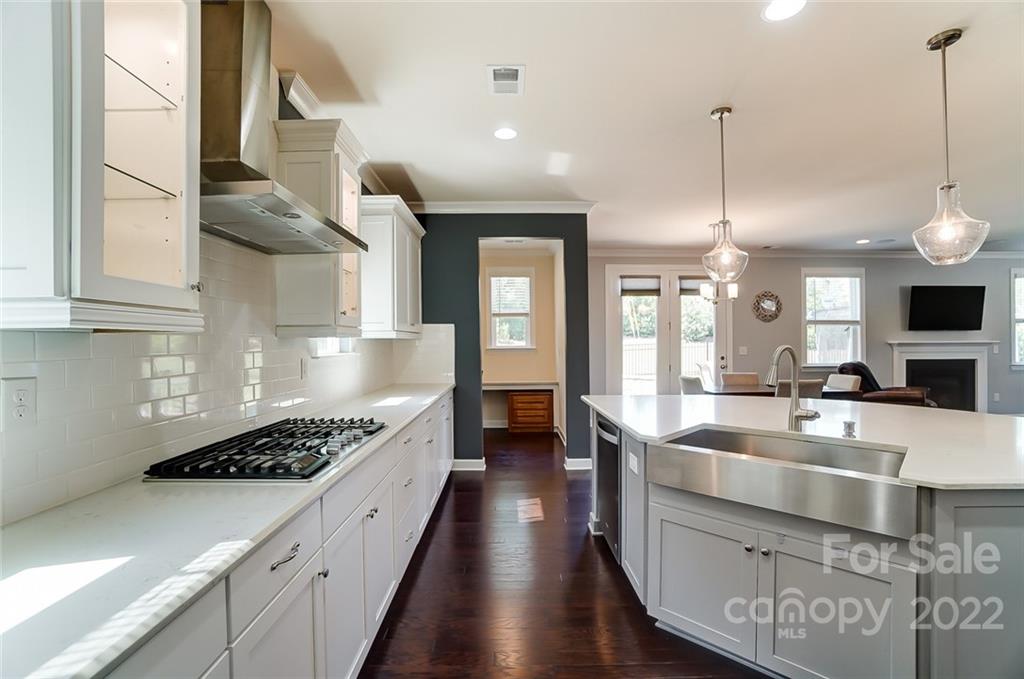 421 Sandbar Point Lake Wylie, SC 29710 - Photo 12 of 48 a large kitchen with stainless steel appliances kitchen island granite countertop a lot of cabinets and wooden floor