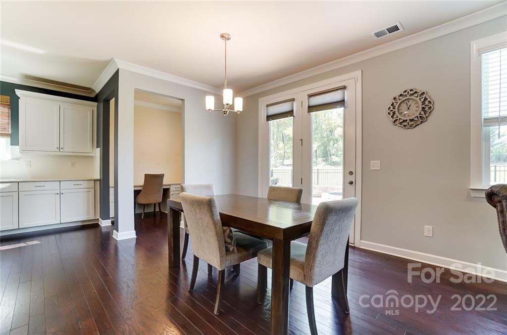 421 Sandbar Point Lake Wylie, SC 29710 - Photo 16 of 48 a view of a dining room with furniture window and wooden floor