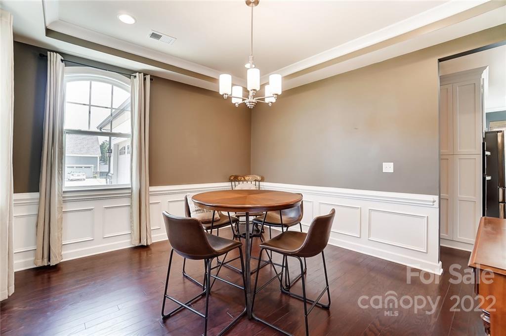421 Sandbar Point Lake Wylie, SC 29710 - Photo 17 of 48 a dining room with furniture a chandelier and wooden floor