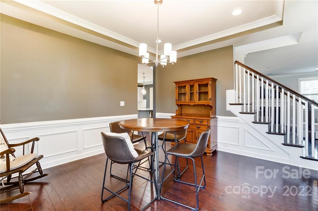 421 Sandbar Point Lake Wylie, SC 29710 - Photo 19 of 48 a view of a dining room with furniture wooden floor and chandelier