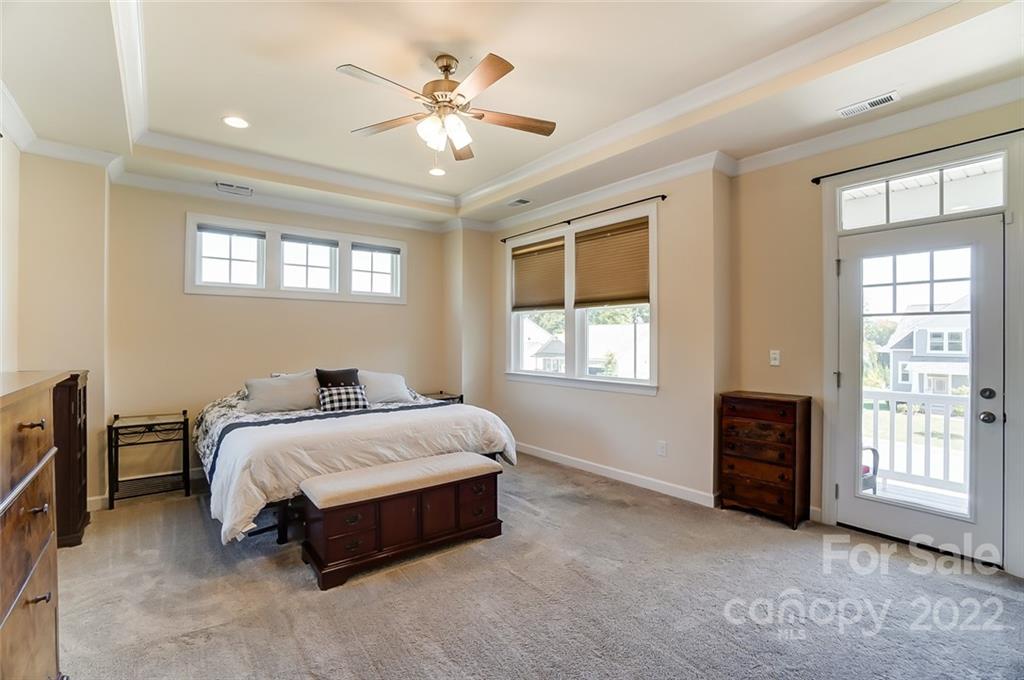 421 Sandbar Point Lake Wylie, SC 29710 - Photo 28 of 48 a spacious bedroom with a bed and a chandelier