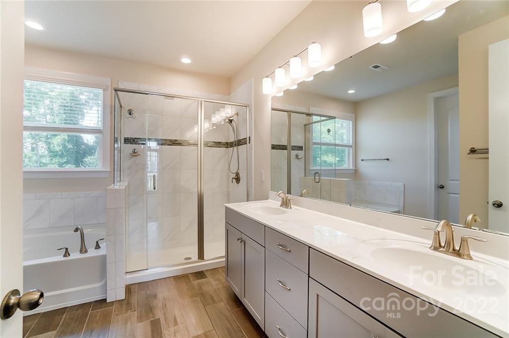 421 Sandbar Point Lake Wylie, SC 29710 - Photo 32 of 48 a bathroom with a granite countertop sink mirror bathtub and shower