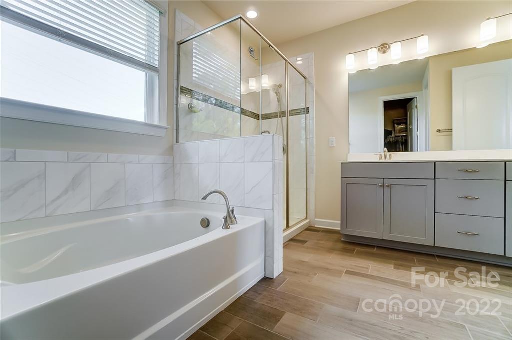 421 Sandbar Point Lake Wylie, SC 29710 - Photo 33 of 48 a bathroom with a bathtub and a shower