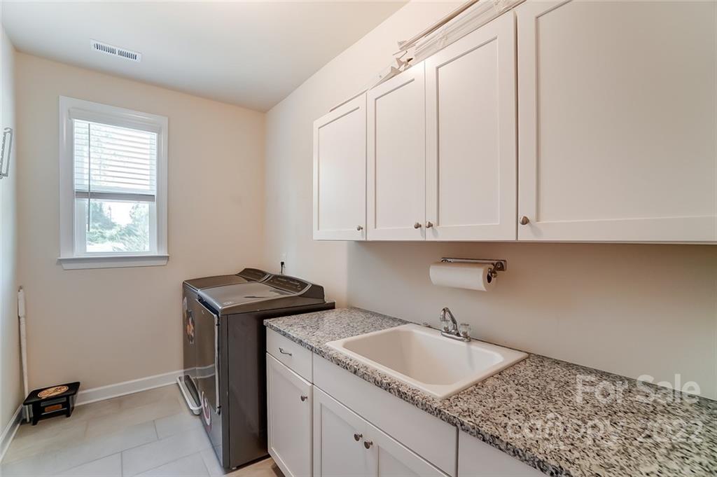 421 Sandbar Point Lake Wylie, SC 29710 - Photo 42 of 48 a kitchen with granite countertop a sink stove and cabinets