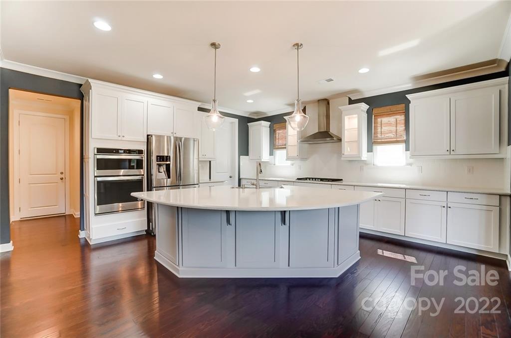 421 Sandbar Point Lake Wylie, SC 29710 - Photo 8 of 48 a kitchen with stainless steel appliances granite countertop a stove a refrigerator and a wooden floors