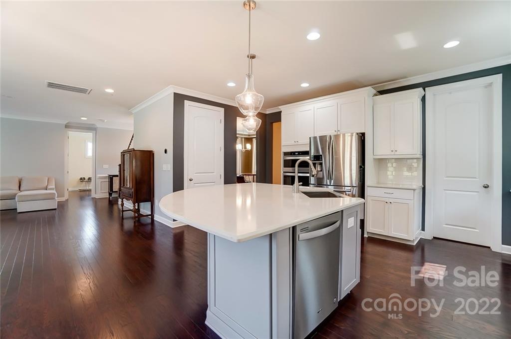 421 Sandbar Point Lake Wylie, SC 29710 - Photo 10 of 48 a kitchen with stainless steel appliances kitchen island hardwood floor sink and stove