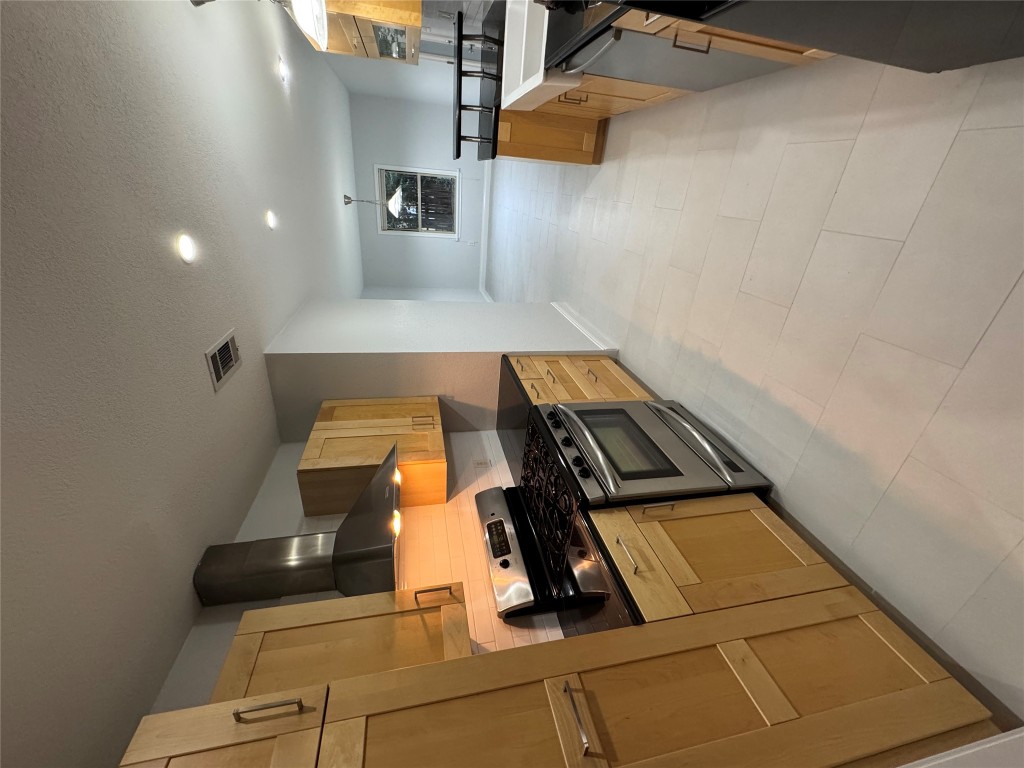 1009 Alegria Road Austin, TX 78757 - Photo 12 of 27 a kitchen with stainless steel appliances granite countertop a stove and a sink