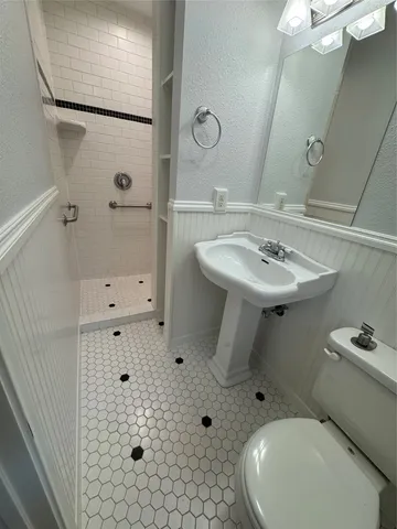 a bathroom with a sink toilet and shower