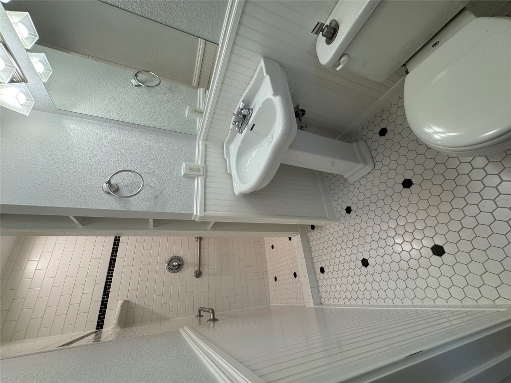 1009 Alegria Road Austin, TX 78757 - Photo 18 of 27 a bathroom with a sink toilet and shower