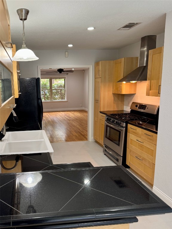 1009 Alegria Road Austin, TX 78757 - Photo 2 of 27 a kitchen with a stove and a refrigerator