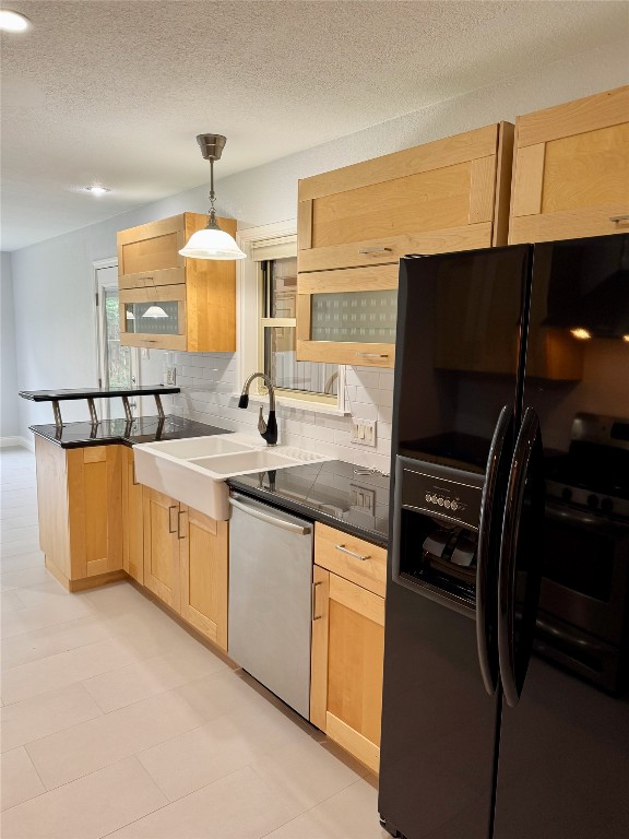 1009 Alegria Road Austin, TX 78757 - Photo 5 of 27 a kitchen with kitchen island granite countertop a sink a stove and a refrigerator