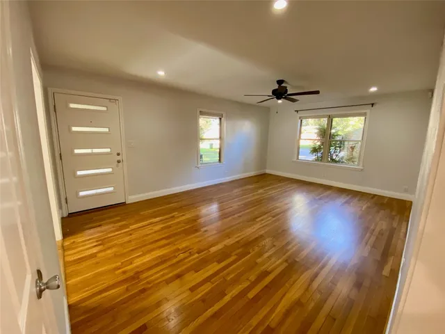 wooden floor in an empty room with a window