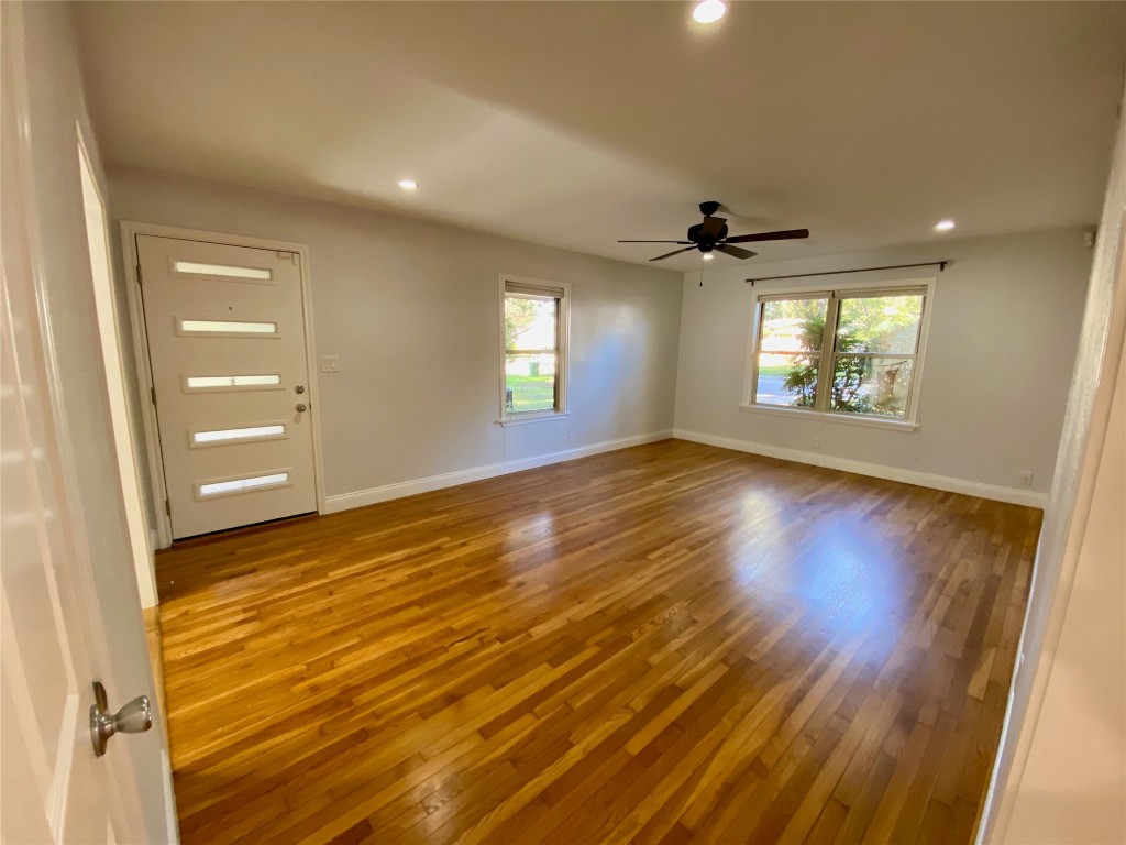 1009 Alegria Road Austin, TX 78757 - Photo 7 of 27 wooden floor in an empty room with a window